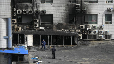 People sit on air conditioners, some jump as fire engulfs China hospital